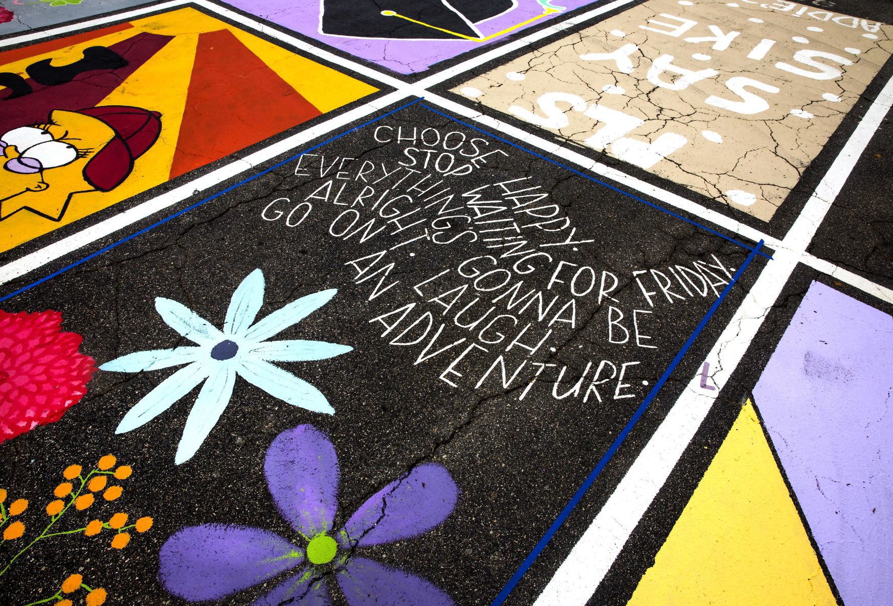 Students painting their parking spaces